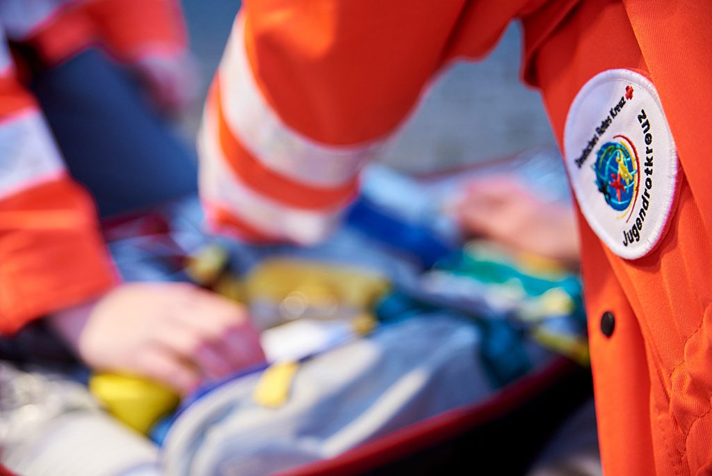 Reportage Jugendrotkreuz - eine Detailaufnahme von Handgriffen am Rettungsrucksack